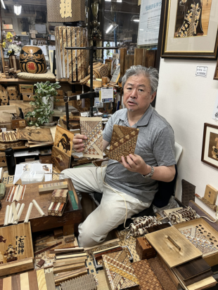 Ichiro Ishikawa explains about Hakone marquetry at Hamamatsuya, his workshop and store in the town of Hakone, Kanagawa Prefecture. | MASAYUKI KAWAI