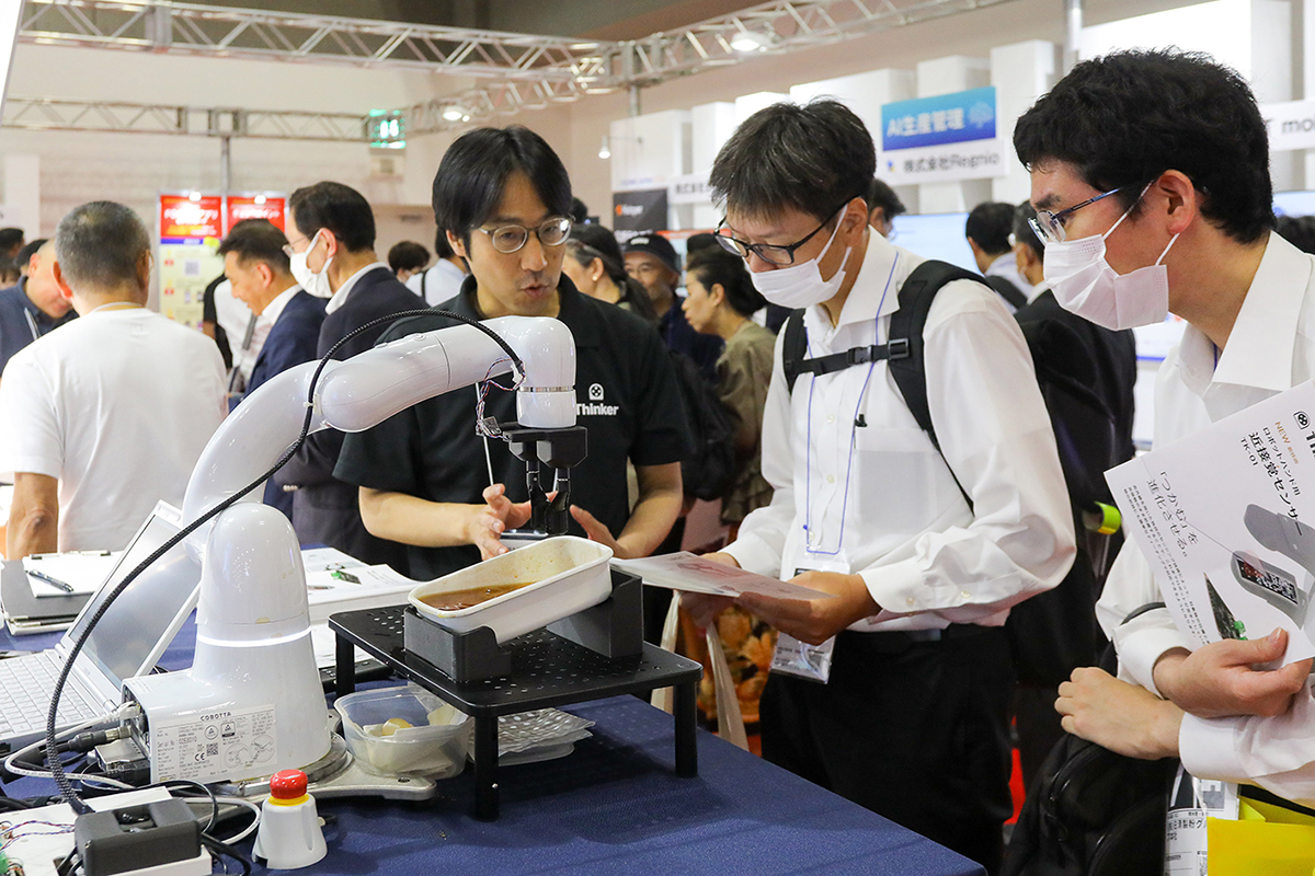 Attendees listen as a vendor speaks about his company’s products at the 2024 show.